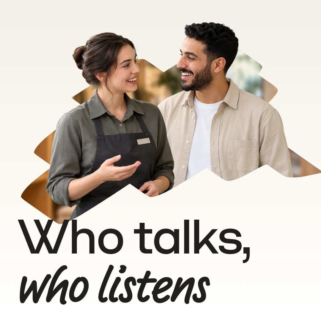 Two people in conversation coming out of a blob filled with a blurred store